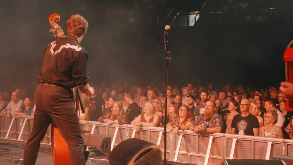 Hyde Family Jam bassist on stage facing a packed crowd
