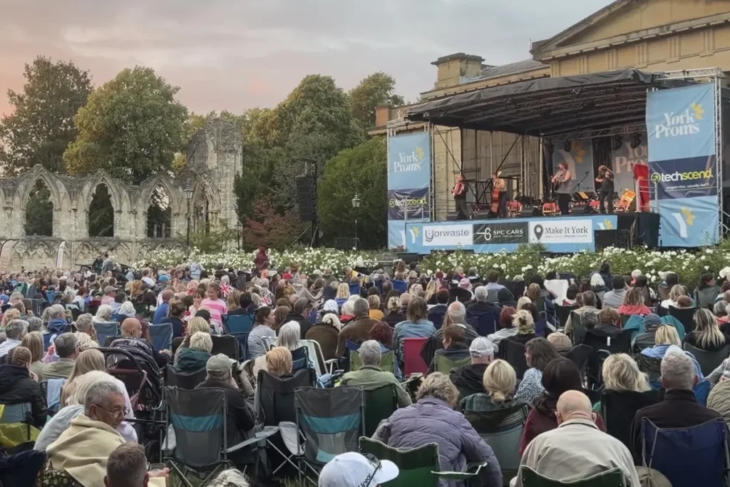 The band on the York Proms stage in Museum Gardens, with the crowd in front