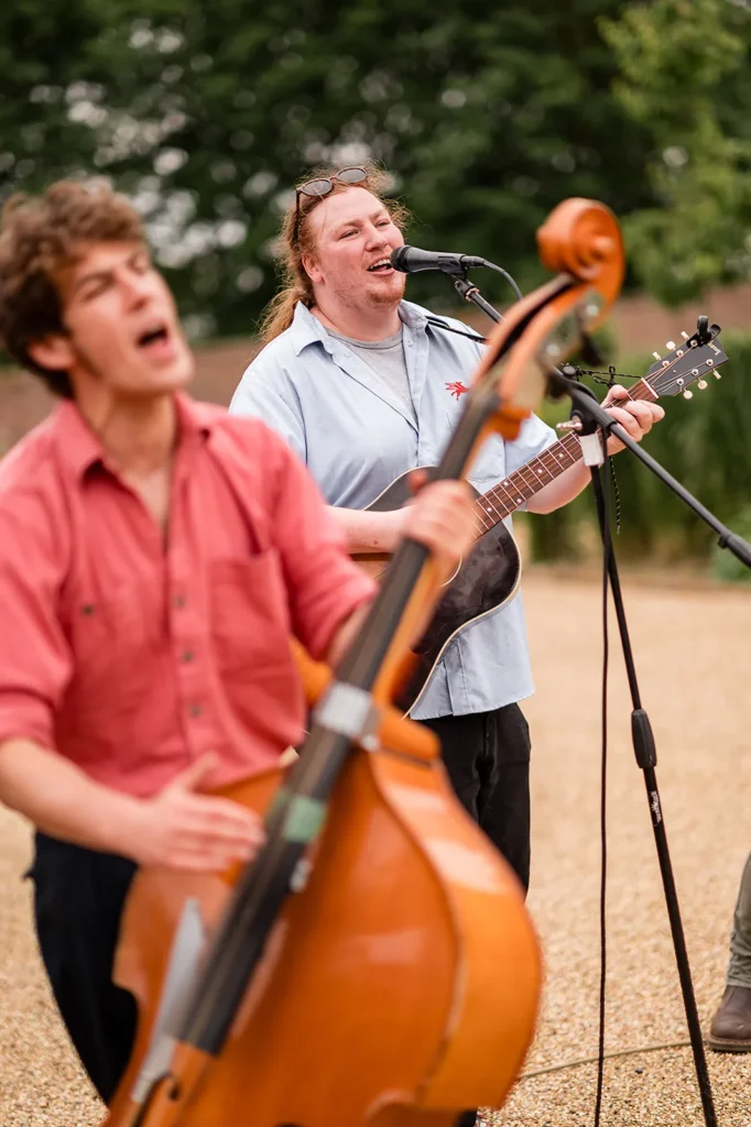 The band playing at a wedding in a walled garden
